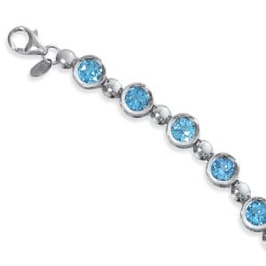 Sterling Silver Bracelet with 12 6mm Blue Topaz Stones by Carla & Nancy B.