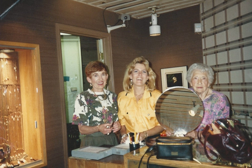 Family members behind the counter in an early photo of the family jewelry shop